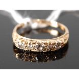 An 18ct yellow gold carved head diamond five-stone half hoop eternity ring, having five graduated