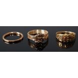 Three rings, comprising a 9ct yellow gold four-strand puzzle ring, size N½, gross weight 2.8g,