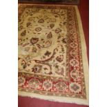 A Persian style woollen rug, having a deep pile, the cream ground decorated with scroll flowers