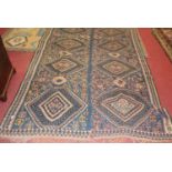 A Turkish woollen Kilim rug, in two sections, having a blue ground with linked medallions, 165 x