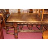 A good 17th century style joined oak four plank refectory dining table, the cleated ends raised on