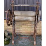 An early 20th century cast iron and wood freestanding mangle