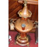 A large circa 1900 copper and brass samovar, the cherub finial over bulbous form shape body with