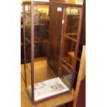 An early 20th century mahogany and glazed table top shop display cabinet, having twin glass interior