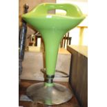 A contemporary green lacquered swivel bar stool raised on chrome metal base