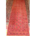 A Turkish woollen Bokhara hall runner, having a red ground and multiple trailing borders, with Kilim