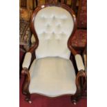 A mid-Victorian mahogany gentleman's spoon back armchair, having buttoned upholstery raised on