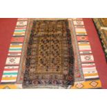 A Turkish woollen prayer rug, having a brown ground decorated with geometric motifs, having Kilim