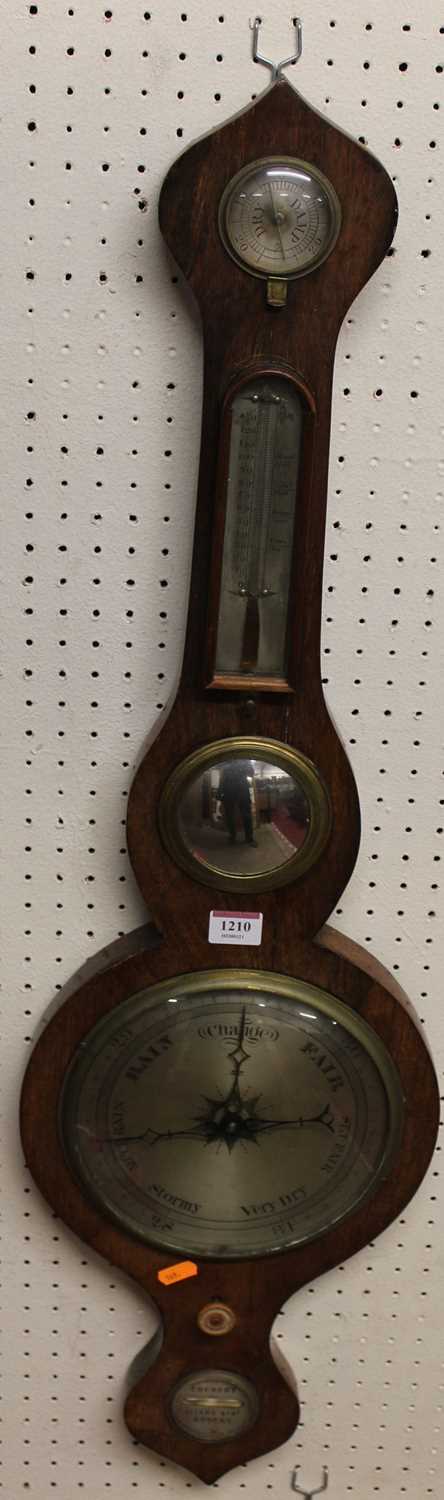 An early 19th century rosewood onion topped four dial wheel barometer, the lower silvered dial