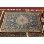 A Persian Qum style rug, having a deep pile, the blue ground decorated with scroll flowers and