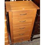 A contemporary light oak narrow chest of five long drawers, width 68cm