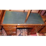 An early 20th century mahogany and rexine inset twin pedestal writing desk, having typical