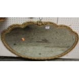 A floral gilt and cream painted bevelled oval shaped wall mirror, 43 x 69cm
