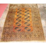 A Turkish woollen Teki-Bokhara rug, the rust coloured field decorated with three rows of