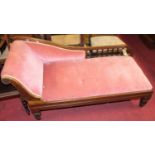 A late Victorian mahogany framed and pink Dralon upholstered chaise longue, raised on shaped