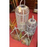 A pair of grey painted wrought iron hanging lanterns (one with single glazed side panel missing),