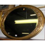 A reproduction gilt framed and bevelled oval wall mirror, 88 x 62cm
