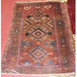 A Turkish woollen prayer rug, the rust coloured field decorated with three linked medallions