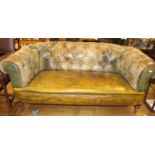 A Victorian green buttoned upholstered and brass studded two seater Chesterfield, raised on turned