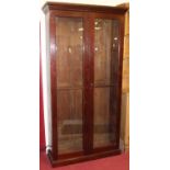 An early 20th century mahogany freestanding double door glazed display cabinet, having later