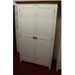 A contemporary white painted double door wardrobe, having light oak cavetto cornice, width 118.5cm