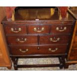 An early 20th century oak chest of three short over two further short and single long lower