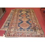 A Persian woollen Isfahan rug, the blue ground decorated with four linked lozenge medallions