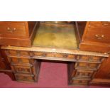 A contemporary joined and moulded oak gilt tooled green leather inset kneehole writing desk,