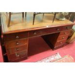 A Victorian mahogany and gilt tooled tan leather inset twin pedestal partners desk, having an