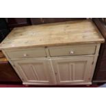 A 19th century rustic pine and part cream painted dresser base, having pull-out slide over twin