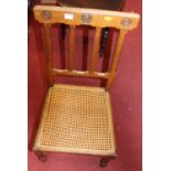 A pair of late Victorian oak cane seat bedroom chairs, together with a further stained wood single