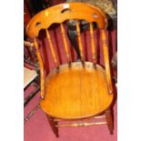 An early 20th century elm and oak stick back tub single pub chair