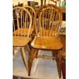 An Ercol light elm stickback kitchen chair, together with three further various elm and beech