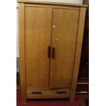 A contemporary light oak double door wardrobe, having single long lower drawer, width 115cm