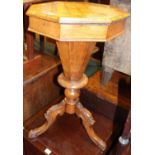 A mid-Victorian figured walnut and specimen wood inlaid octagonal hinge top sewing table, having a