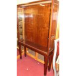 An early 20th century mahogany and glazed freestanding single door shop display cabinet, height