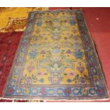 A Caucasian woollen rug, the yellow ground decorated with vases issuing flowers and foliage within