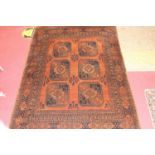 A Turkish woollen Bokhara rug, having a brown ground decorated with two rows of medallions within