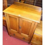 A 1930s oak ledgeback double door side cupboard, having single long lower drawer, width 76cm