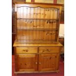 A modern pine kitchen dresser, having open upper plate rack within spiral turned columns, width