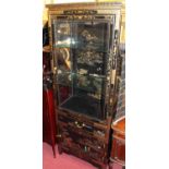 A contemporary Oriental black lacquered and gilt decorated display cabinet, having glazed door