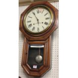 A Seth Thomas stained wood drop trunk wall clock, with signed dial and pendulum, height 65cm