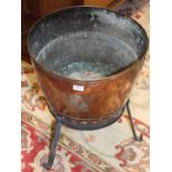 A 19th century riveted copper circular log bucket on wrought iron stand, dia. 42cm