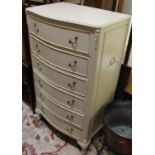 A contemporary French white wood serpentine front chest of six long drawers, raised on acanthus leaf