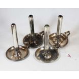 A set of four late 19th century silver plated chambersticks, each with engraved armorial to the