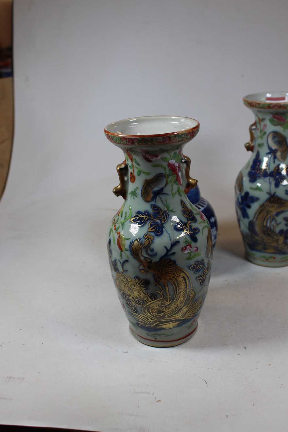 A pair of stoneware vases, each of baluster form, enamel decorated with various birds, butterflies - Image 2 of 13