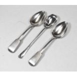 A pair of George III silver serving spoons in the fiddle pattern, together with one other silver