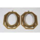 A pair of late 19th century gilt metal frames, each of octagonal form with scrolling floral