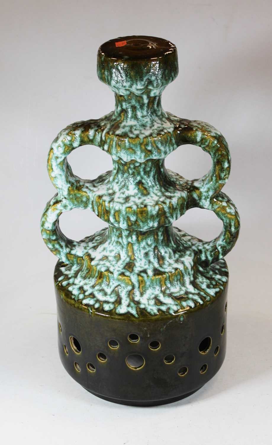 A 1970s West German green glazed pottery lamp base, having four loop handles to a pierced circular