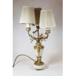 A late 19th / early 20th century alabaster and gilt metal mounted three branch table lamp, the three